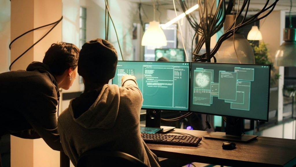 Male hacker using knowledge of computer science to access important data
